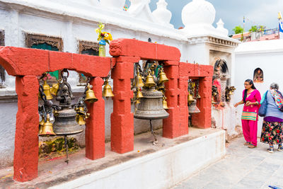 People outside temple against building