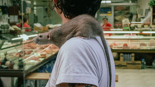 Rear view of woman standing in market