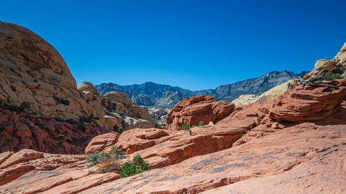 Scenic view of mountains against clear blue sky