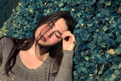 Young woman sleeping on field in park