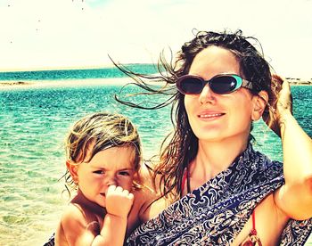 Portrait of a young woman standing on beach