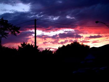 Silhouette trees against sky during sunset