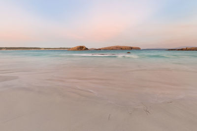 Scenic view of beach against sky during sunset