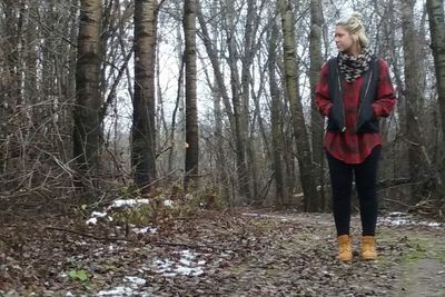 Woman standing in forest