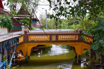 Bridge over lake against trees