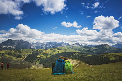 Rear view of people on mountains at corvara