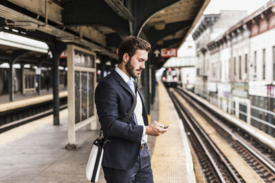 Man standing at railroad station