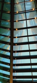 Low angle view of illuminated building seen through window