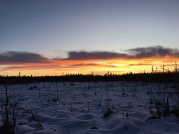 Scenic view of frozen lake against sky during sunset