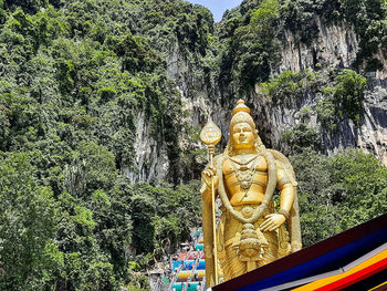 Statue of buddha against trees