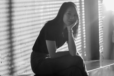 Portrait of woman sitting on bench
