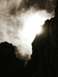 Low angle view of mountain against cloudy sky