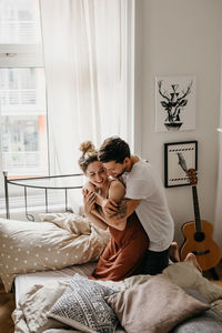 Couple kissing on bed at home