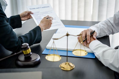 Midsection of lawyer working in courtroom