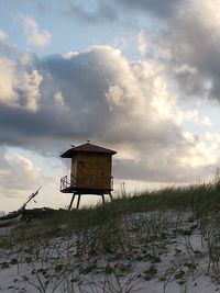 Built structure by lake against sky