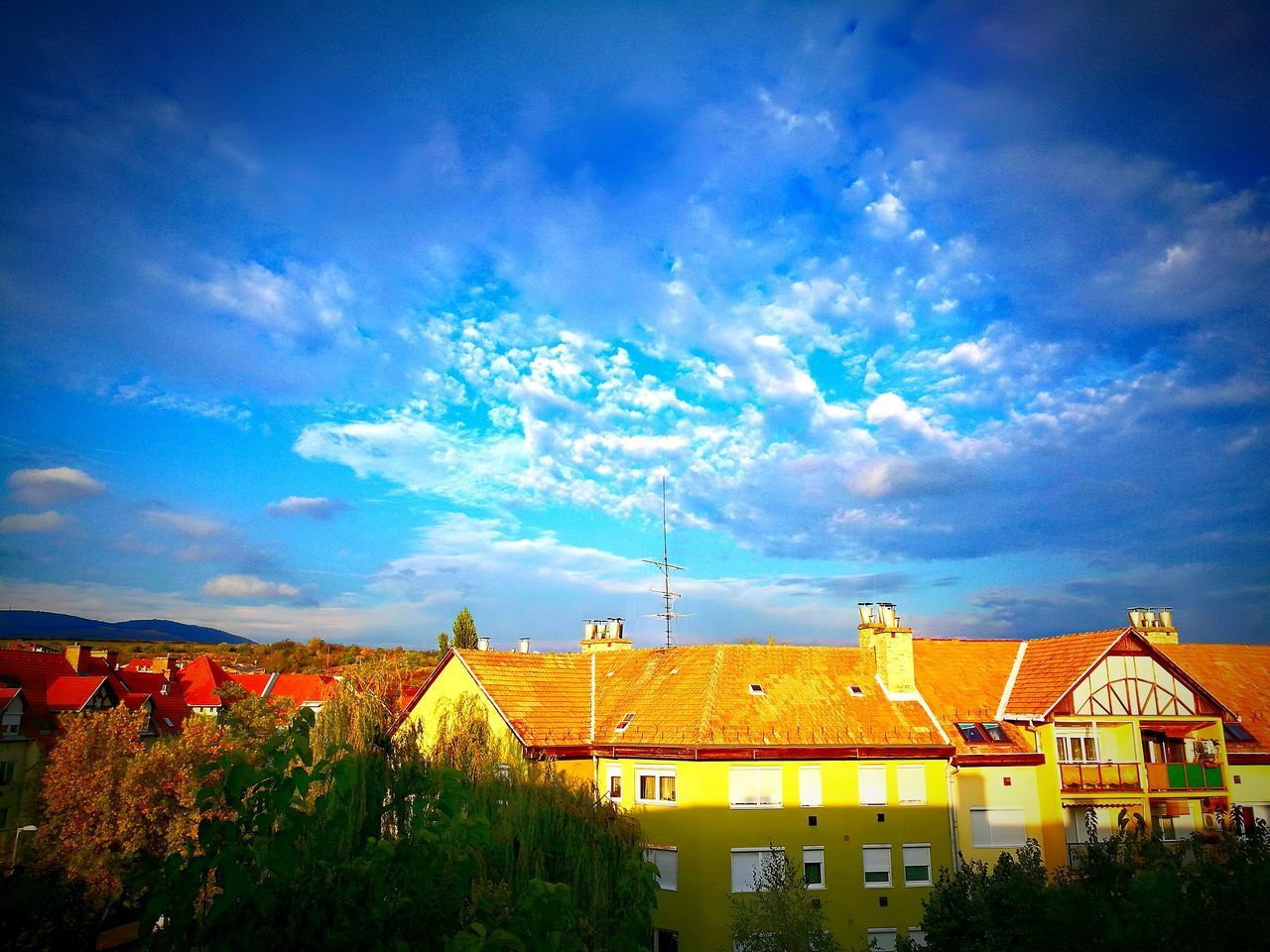 HOUSES AGAINST BLUE SKY IN CITY