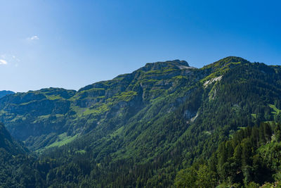 Scenic view of mountains against clear blue sky