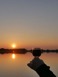 Scenic view of river against sky during sunset