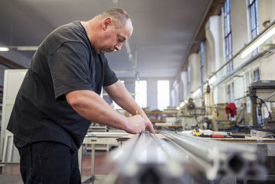 Man in factory working on metal component