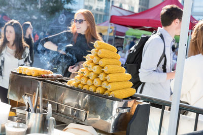 People having food on barbecue grill