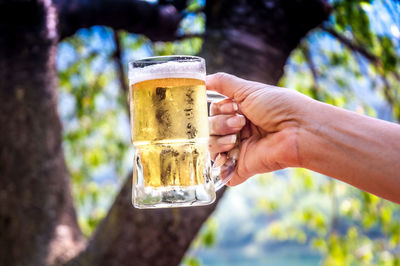 Hand holding glass of beer