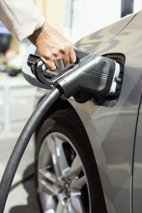 Woman's hand refueling car