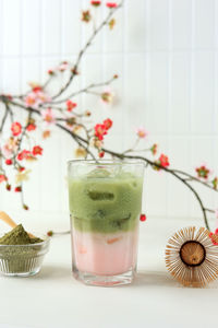 Iced sakura green tea milk on white table