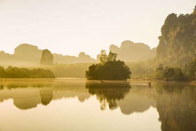 Scenic view of lake and mountains against clear sky