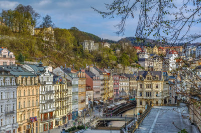 High angle view of street by buildings against sky