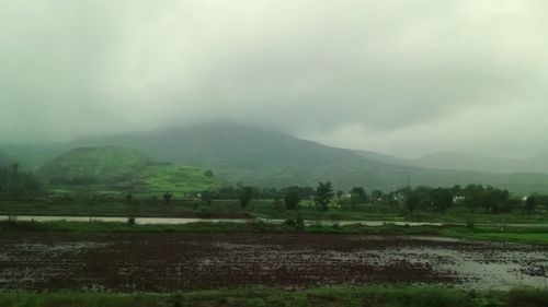 Scenic view of landscape against cloudy sky