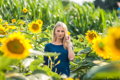 Portrait of woman standing at sunflower farm