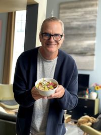 Portrait of man holding a bowl of healthy food