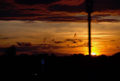 Silhouette trees against sky during sunset