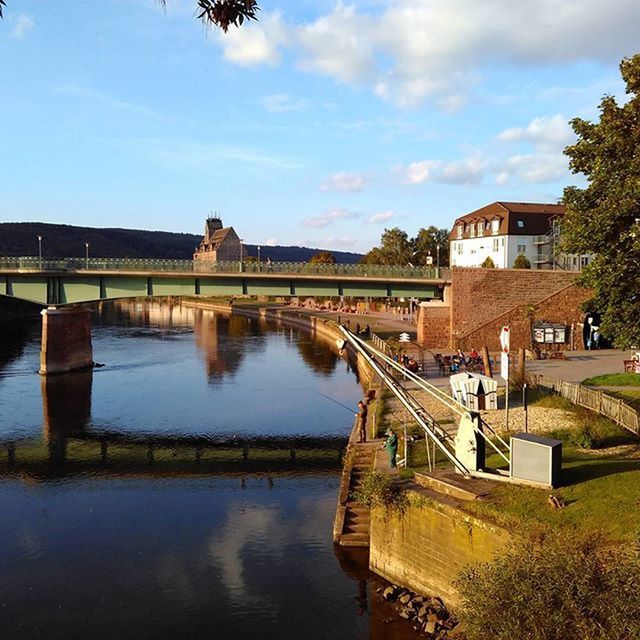 architecture, built structure, water, building exterior, sky, tree, canal, river, cloud - sky, bridge - man made structure, reflection, connection, waterfront, cloud, house, day, outdoors, residential structure, no people, nature