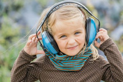 Portrait of smiling girl wearing headphones