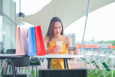 Woman sitting on table