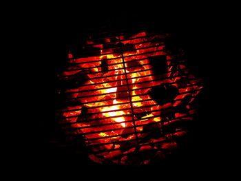 Close-up of illuminated fire against black background