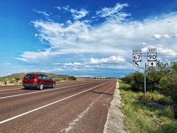 Cars on road against sky