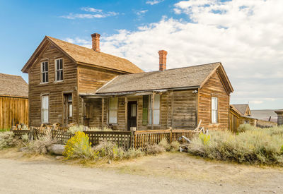 Old house on field against sky