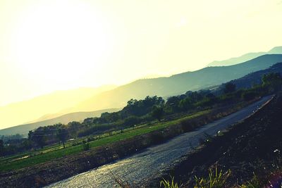 Scenic view of agricultural field against sky during sunset