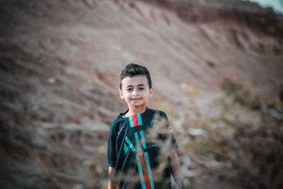 Portrait of boy standing outdoors