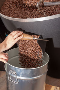 Ready roasted coffee beans are filled in a container