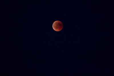 Low angle view of moon against sky at night