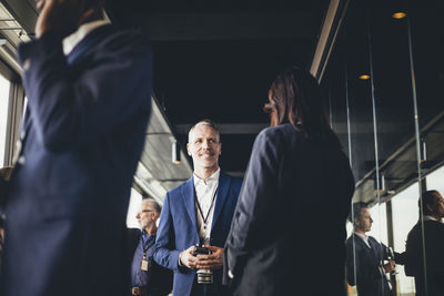 Low angle view of male and female business professionals standing at workplace