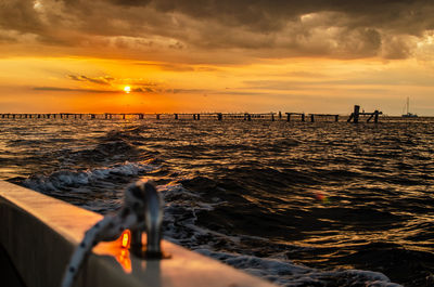 Scenic view of sea against orange sky