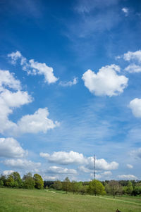 Scenic view of field against blue sky