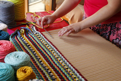 Midsection of woman knitting wool