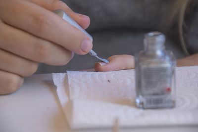 Close-up of person holding hands on table