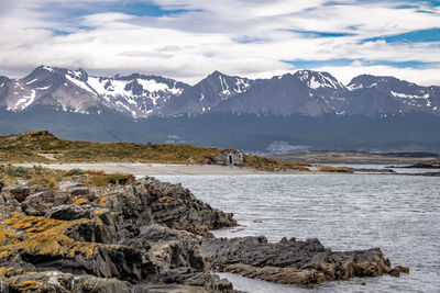 Scenic view of sea and mountains against sky