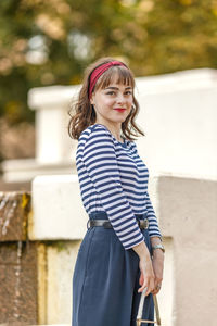 Portrait of young woman standing outdoors